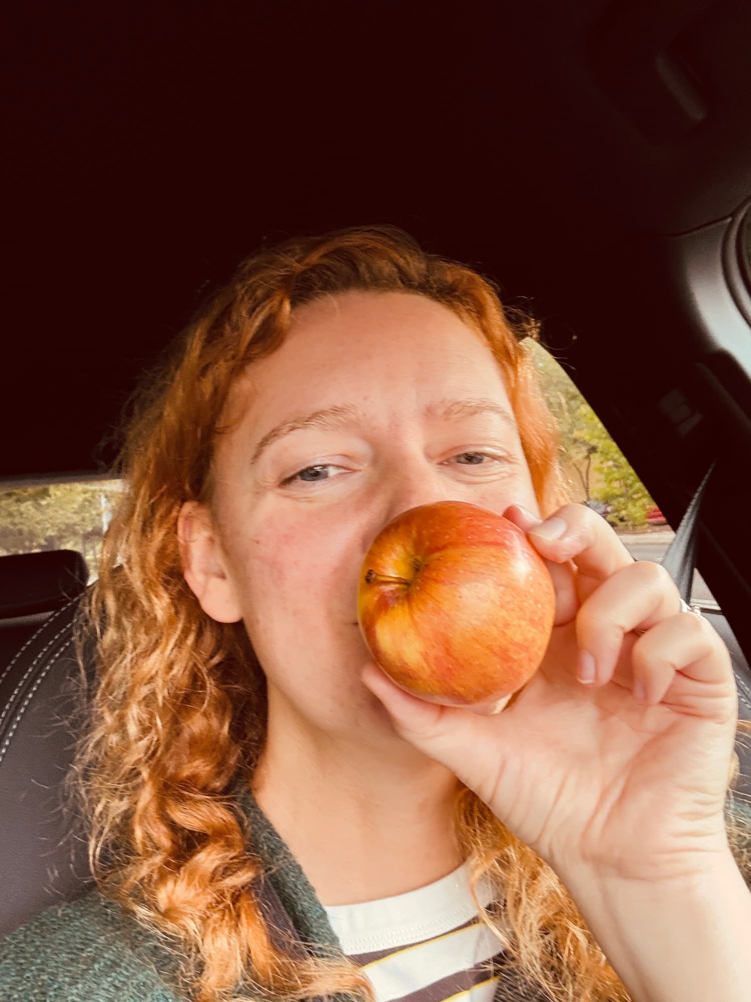 Vaiva Rivas smiling behind a red apple